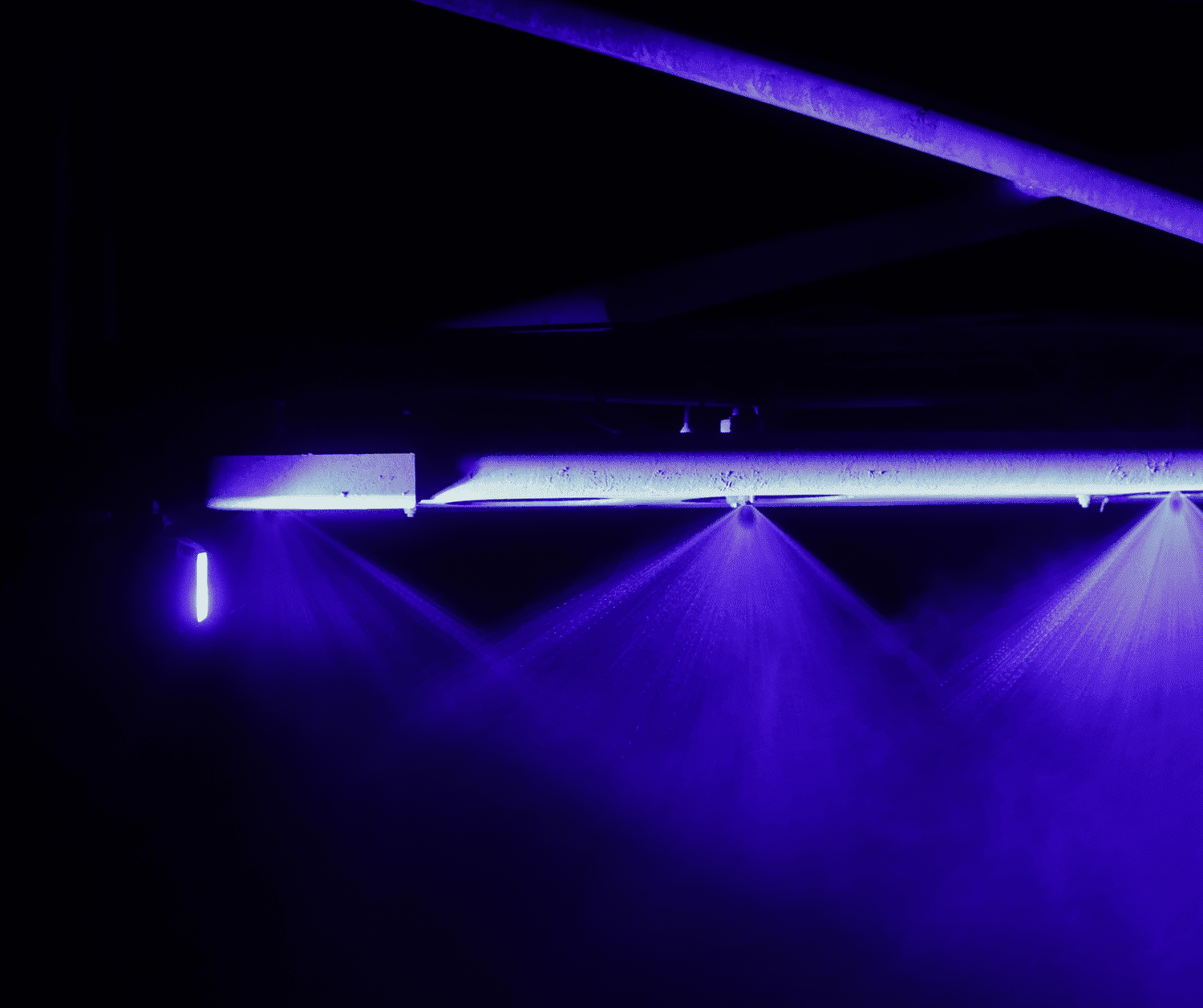 MURDA Mega Spray LEDs mounted under spray boom — multiple violet-blue beams illuminated at night